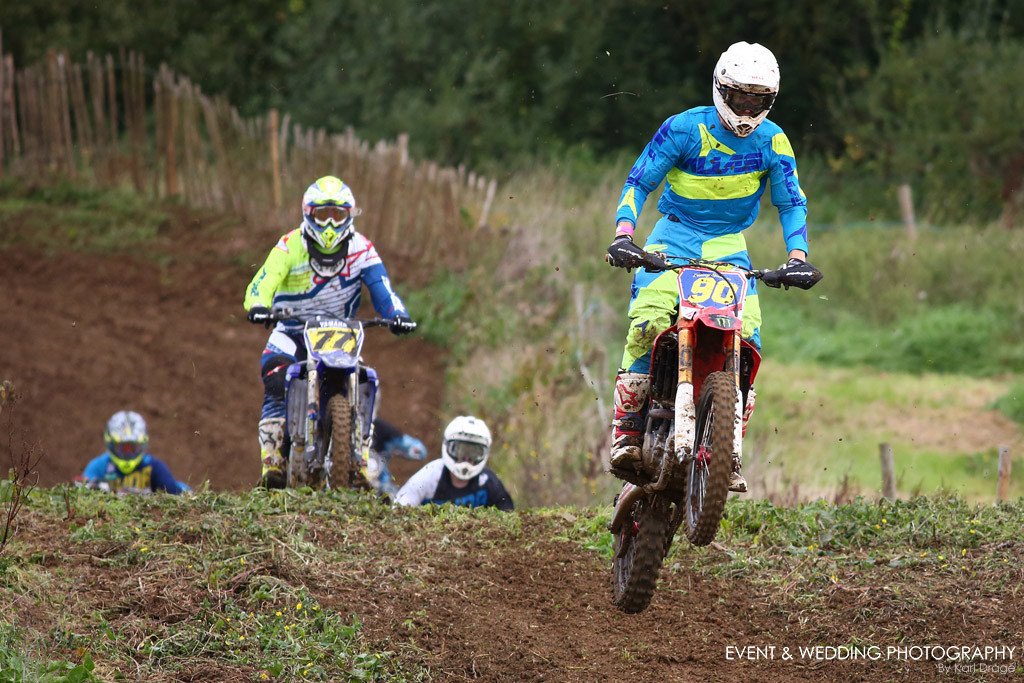 Long lens shot of riders over a jump at Woodford motocross track.