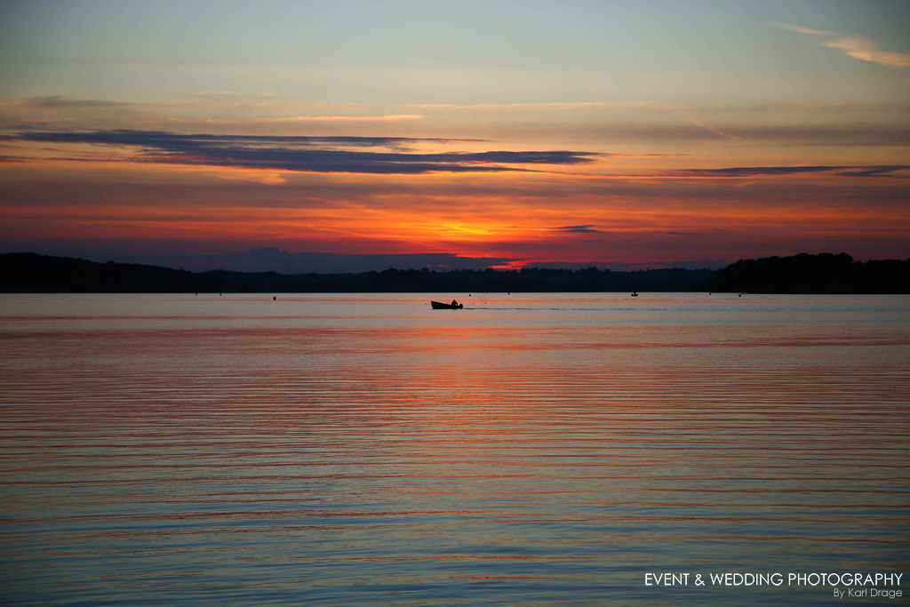 A fishing boat makes its way back to shore at Rutland Water after sunset © Karl Drage / eventandweddingphotography.co.uk