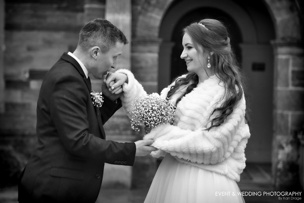 A kiss on the hand for his beautiful bride on her wedding day at Delapre Abbey.