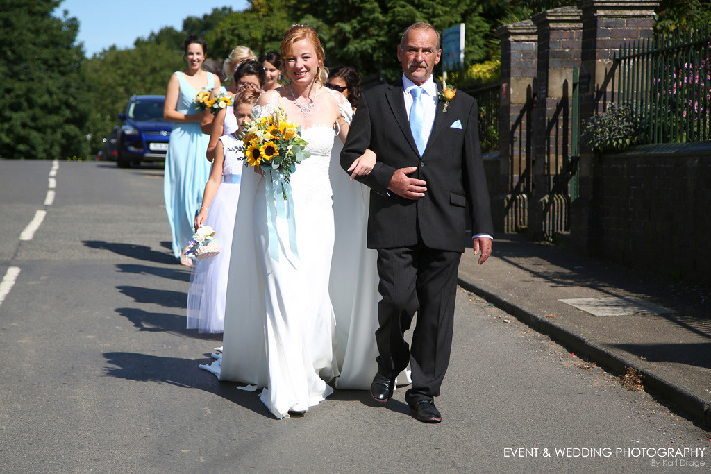 The wedding procession takes over the main road through Rushton, Northants.