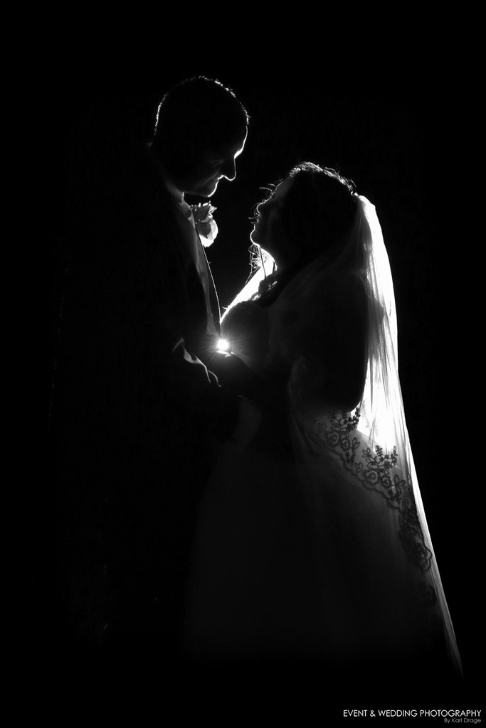 After-dark silhouette of the happy couple - by Northampton wedding photographer Karl Drage