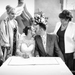Signing the wedding register before your witnesses - by Milton Keynes wedding photographer Karl Drage