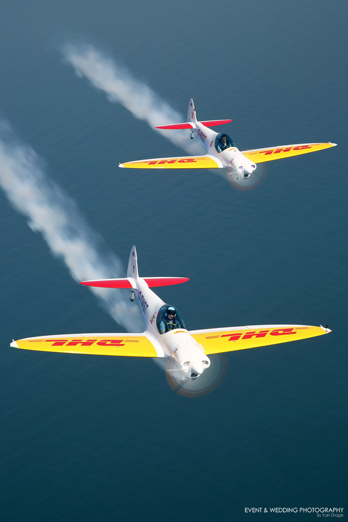 The Silence Twisters of Twister Aerobatics trail their smoke over the sea just off of Dubai's Palm Jumeirah
