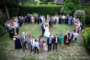 Love is all around them! Beautiful heart-shaped wedding group shot