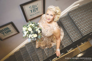 Image showing a bride heading down the stairs en route to her wedding ceremony.