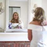 Bride reflected in a mirror before her wedding day.