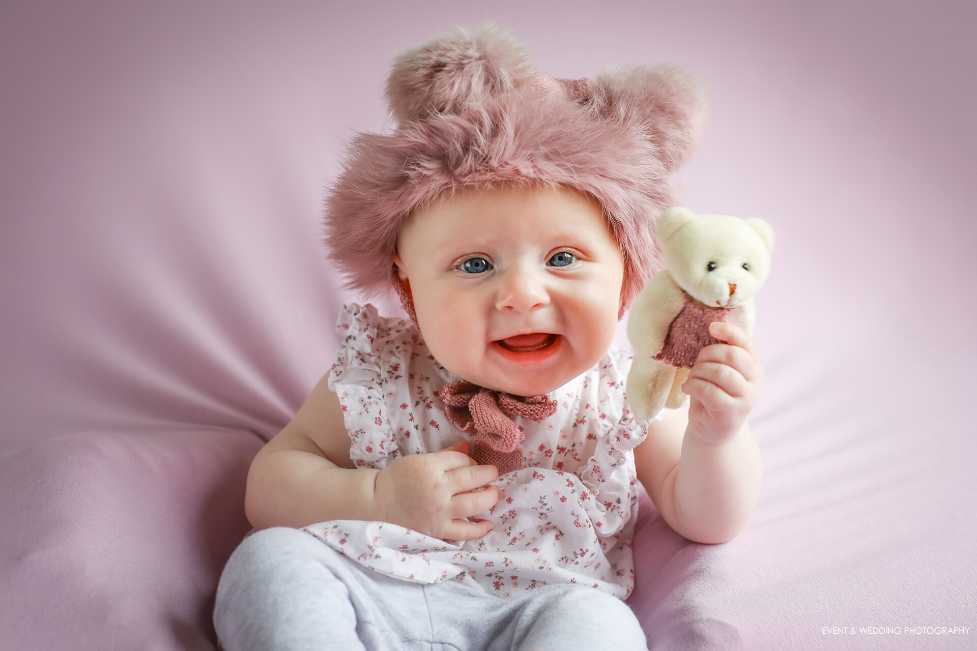 Baby girl wearing a teddy bear ears hat for her sitter session