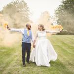 Bride and Groom carrying smoke bombs on their wedding day
