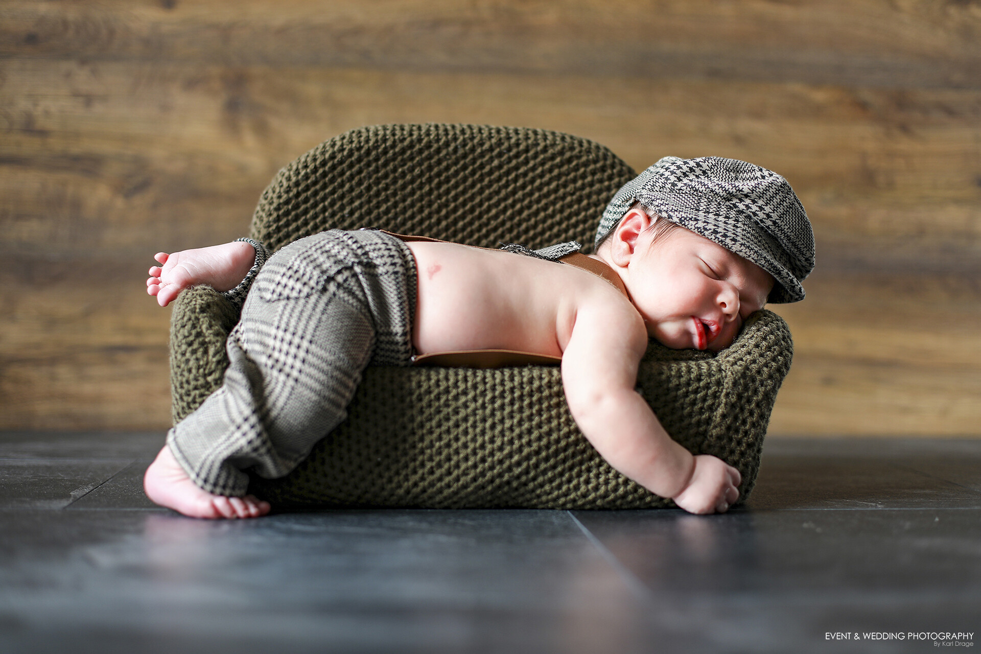 Newborn baby asleep on a sofa photo prop