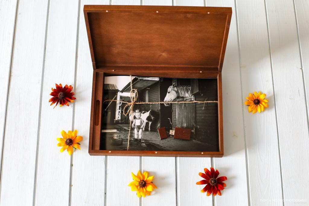 Photo of a wooden presentation box containing a photograph of a young boy and a horse