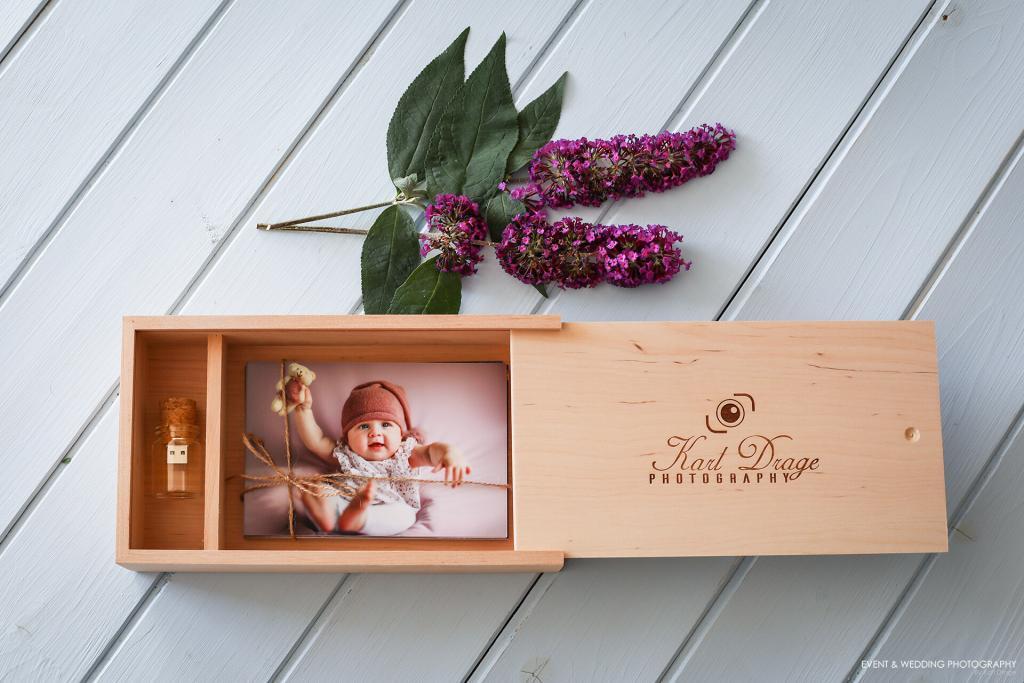Photo of a natural wood presentation box containing a print of a baby taken during a sitter photography session
