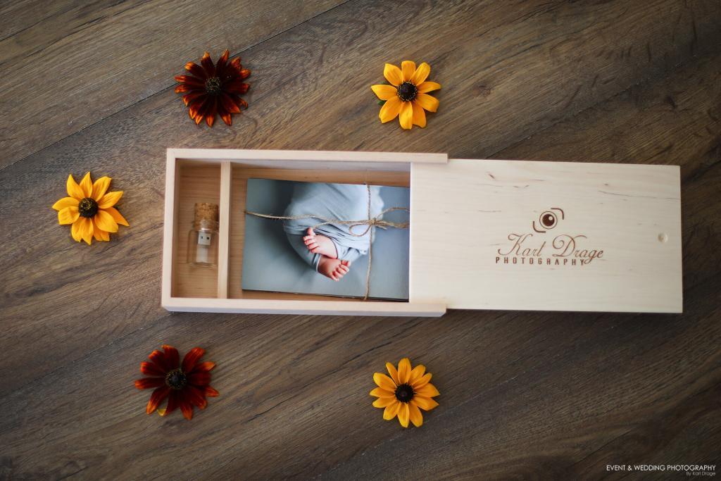 Photograph of a print of a baby's wrapped feet in a wooden presentation box