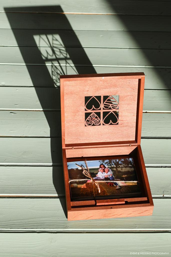 Photo showing a wooden presentation box containing a print from a family photoshoot