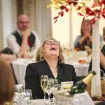 Guest at a wedding laughing at the speeches