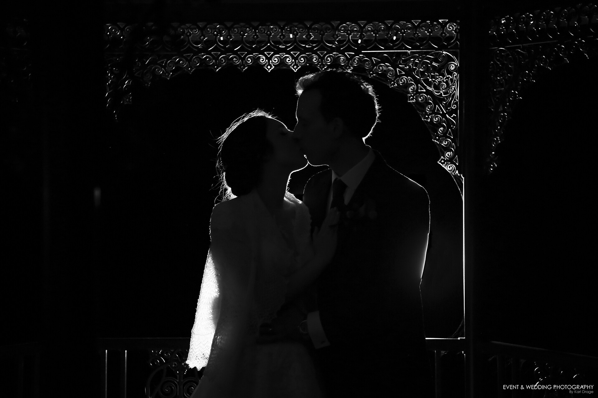Edge-lit silhouette shot of a bride and groom on their wedding day