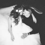 A bride and groom share a chair and an embrace at a Sedgebrook Hall wedding