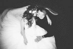 A bride and groom share a chair and an embrace at a Sedgebrook Hall wedding