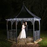 Bride and groom in a pagoda at night