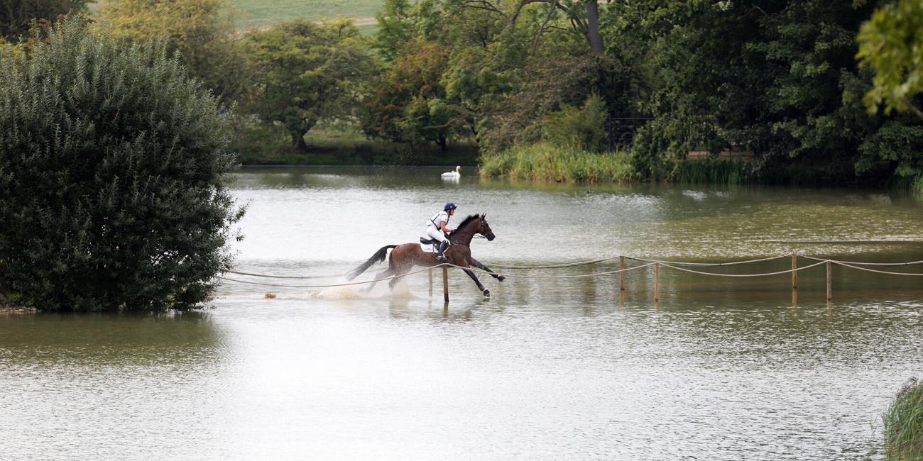Bubby Upton & Cola III skim across the water at The Boodles Raindance at Land Rover Burghley 2022