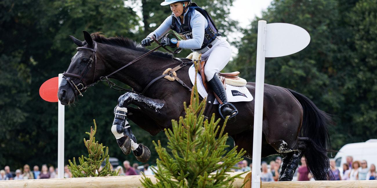 Jonelle Price & Classic Moet sail out over the sizeable Oxer Over Ditch at the 2022 Land Rover Burghley Horse Trials