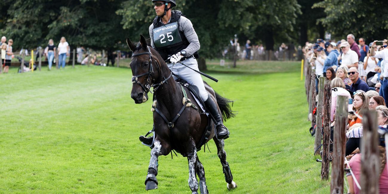 Tom Crisp & Liberty And Glory approach the Oxer Over Ditch at the Burghley Horse Trials 2022