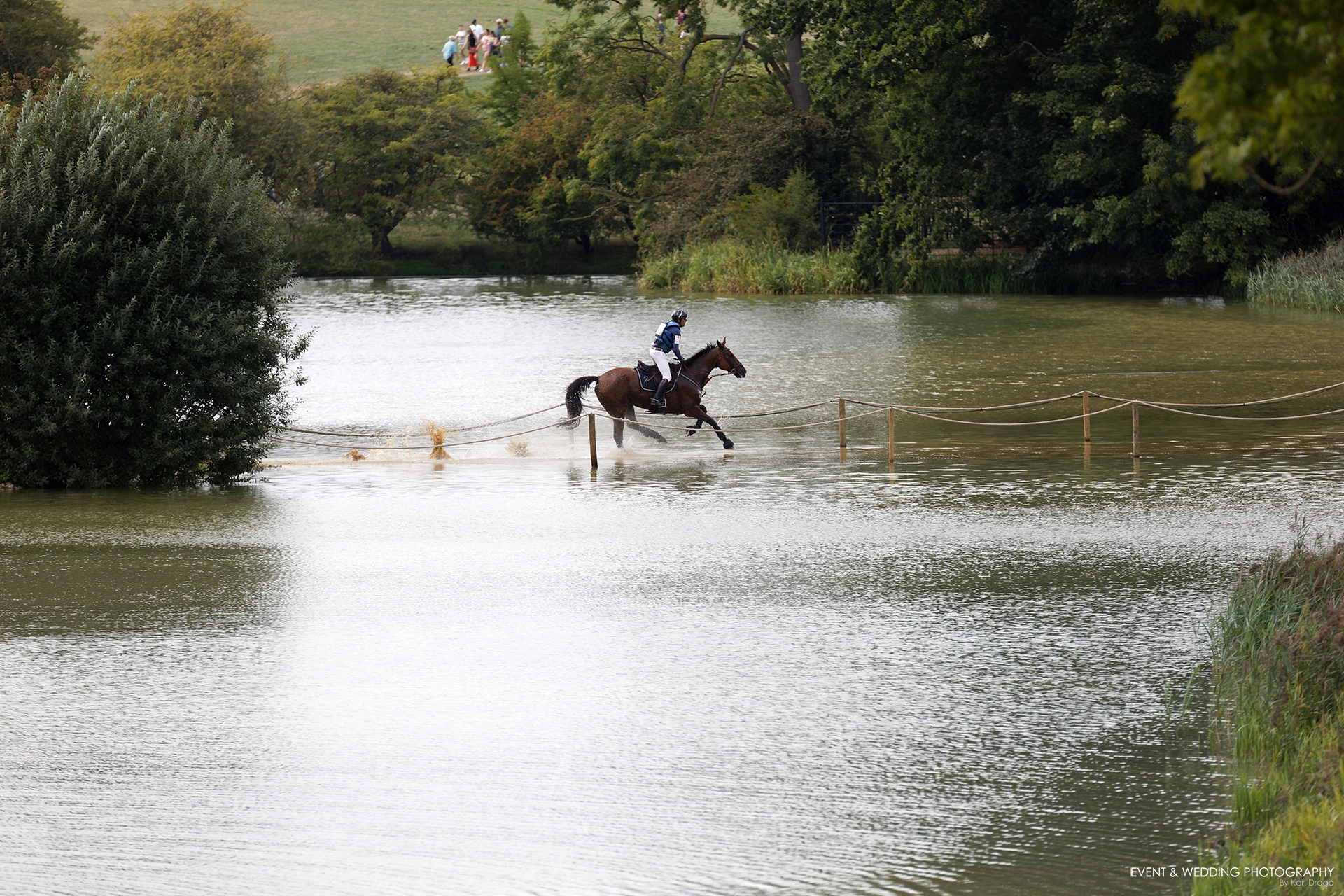 Cedric Lyard & Unum De'Or turn the corner splashing through the Boodles Raindance during the 2022 Burghley Horse Trials