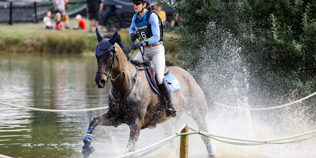 Sarah Clark & LV Balou Jeanz splash through the Boodles Raindance at the 2022 Burghley Horse Trials.