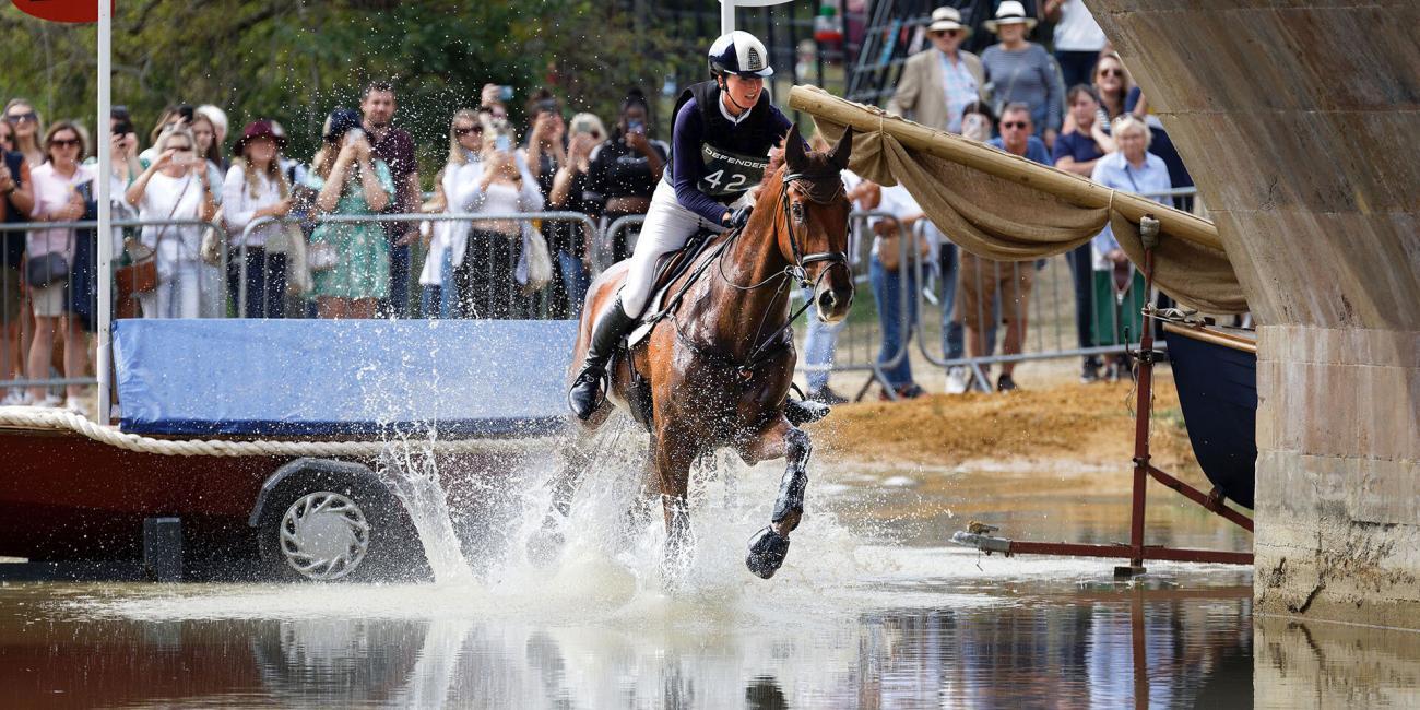 Hollie Swain & Solo land in the water at Lion Bridge, Burghley, during the 2022 Burghley Horse Trials