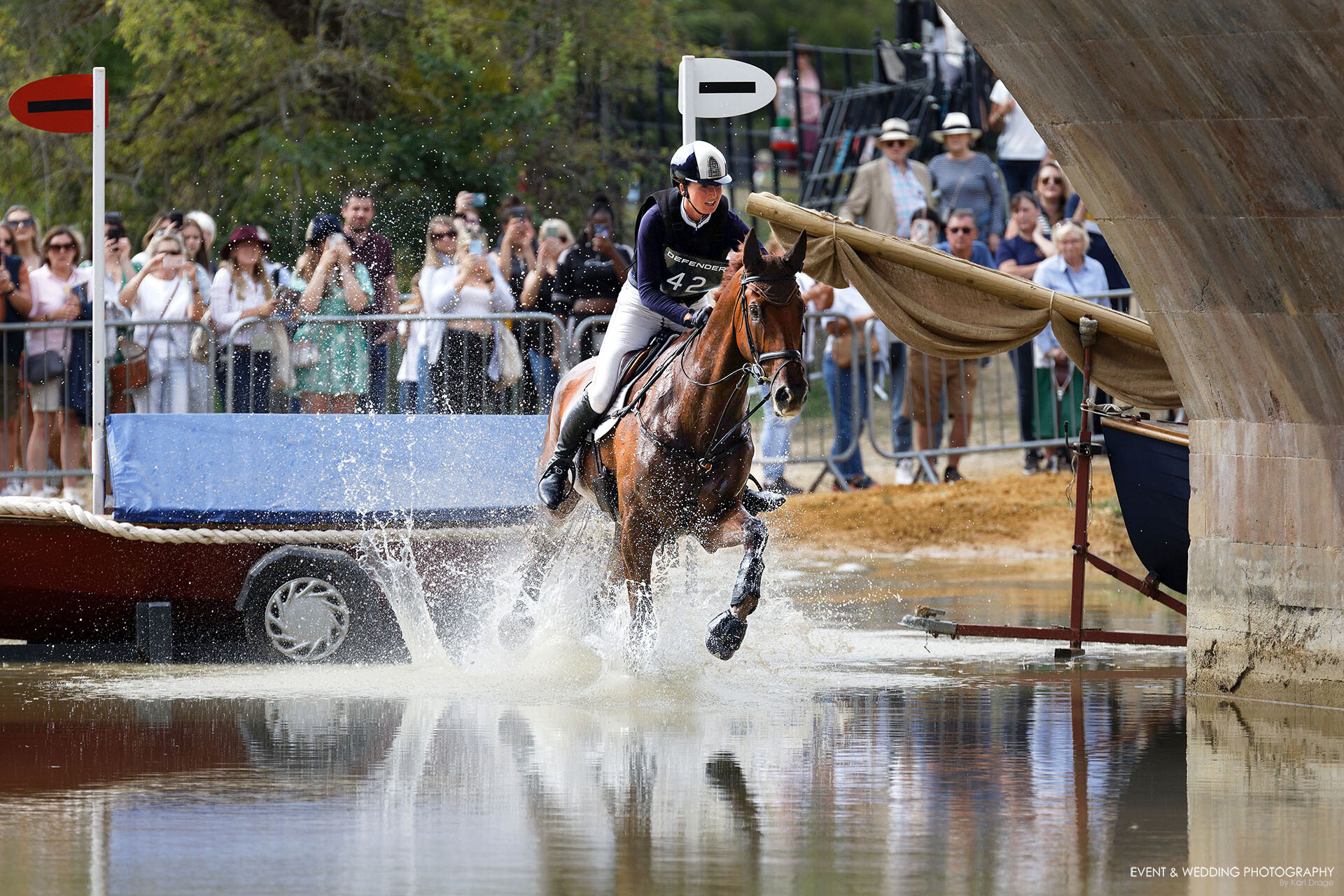 Hollie Swain & Solo land in the water at Lion Bridge, Burghley, during the 2022 Burghley Horse Trials