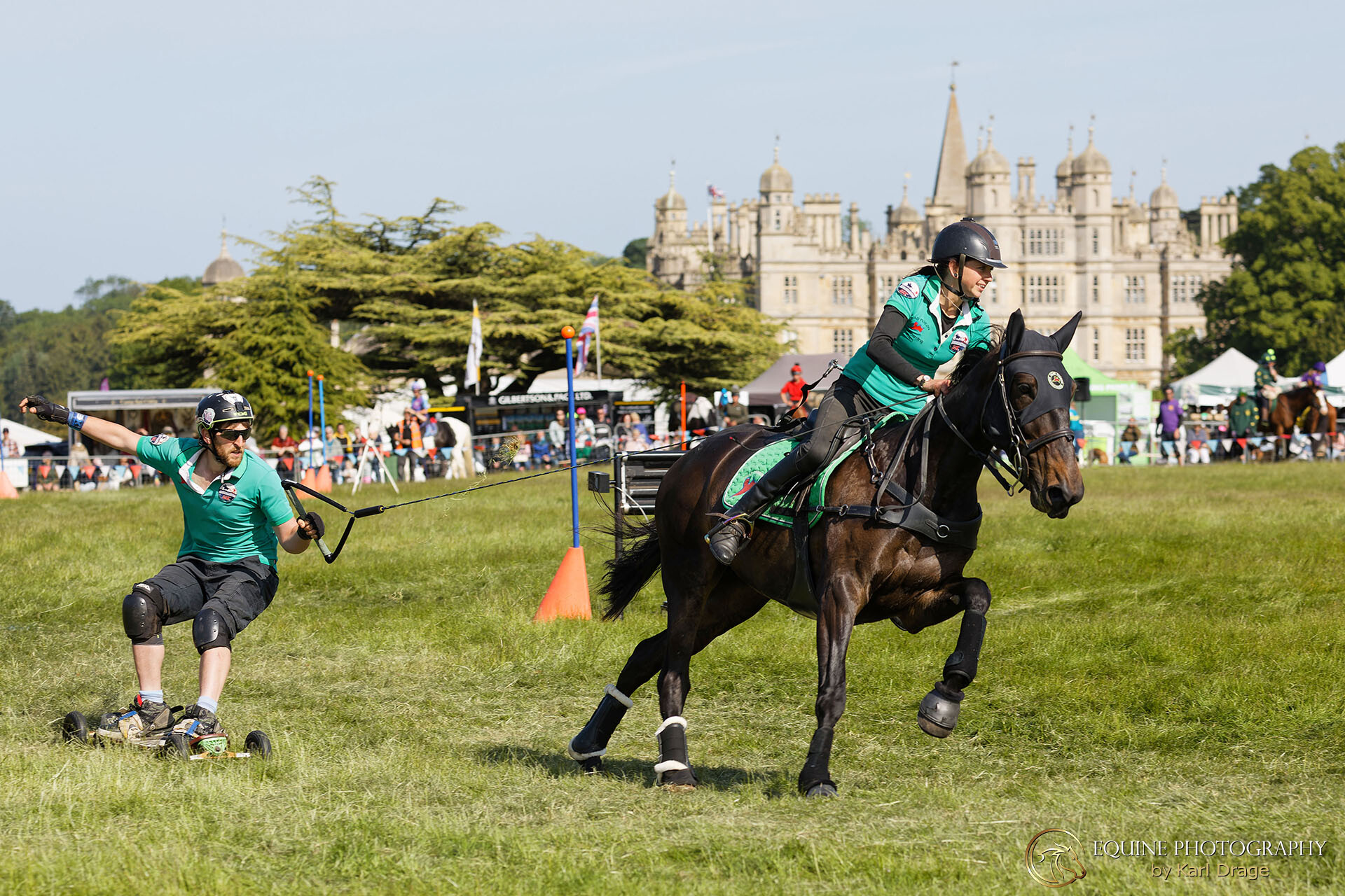 The Dead Pigeon horseboarding team pass Burghley house during the Burghley Game & Country Fair round of the 2023 National Horseboarding Championship