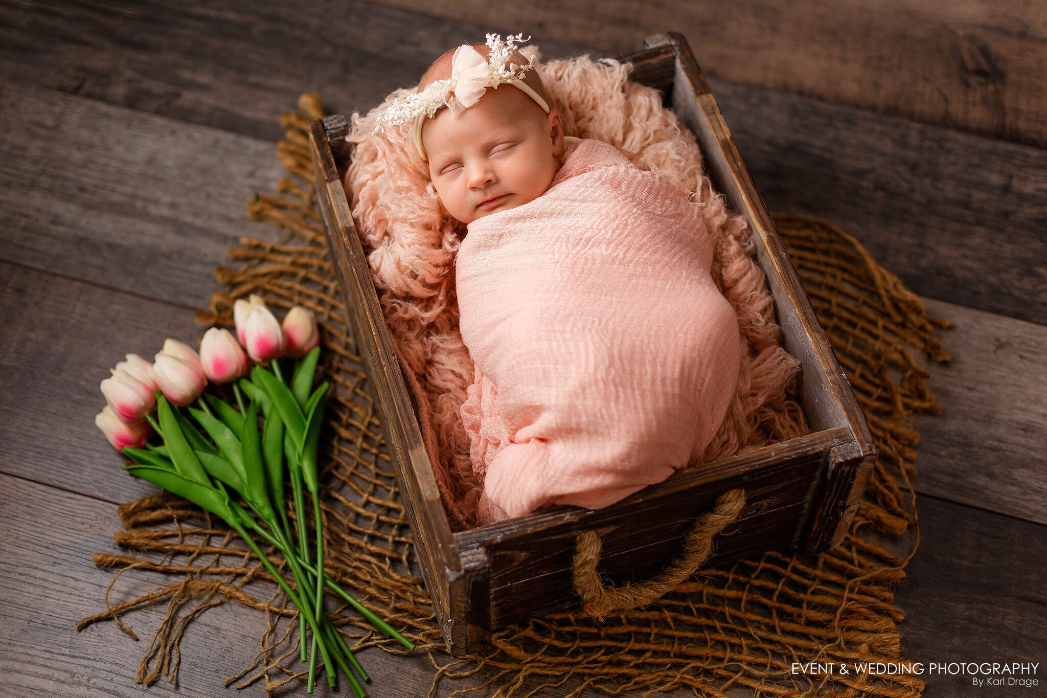 Newborn baby girl asleep in a brown rustic drawer photo prop during her Corby newborn photo shoot.