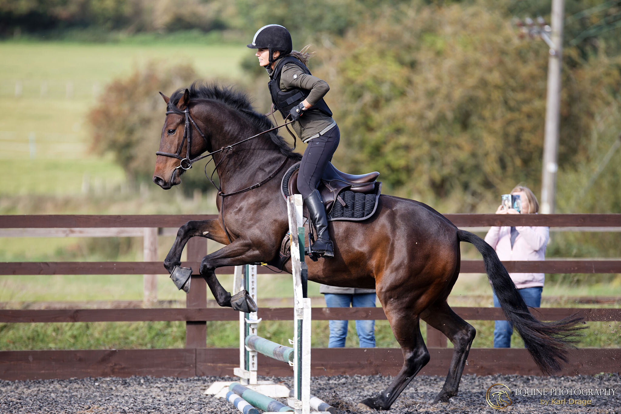 A horse and rider jump an obstacle during a Clear Round showjumping session at Boughton Mill Equestrian Centre