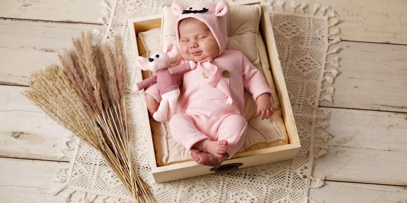 The cutest newborn baby girl wearing a pink mouse outfit, asleep in a drawer - Karl Drage, Northampton Newborn Photographer